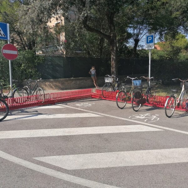 Rood fietsenrek Gamma met geparkeerde fietsen op een openbare parkeerplaats