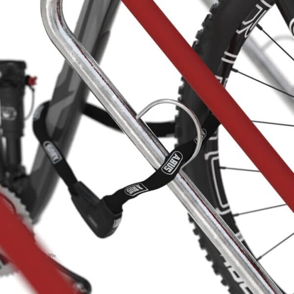 Detail slotoog aan fietsenrek met kettingslot Close-up van slotoog aan fietsenrek met kettingslot door fietsframe, detail van rode beschermlaag zichtbaar