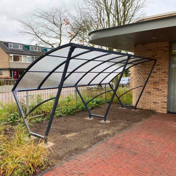 kleine-fietsoverkapping-aanschaffen-marne Duurzame rijwieloverkapping van 5 meter met een stevig stalen frame en een transparant polycarbonaat dak, perfect voor bescherming tegen weersinvloeden.