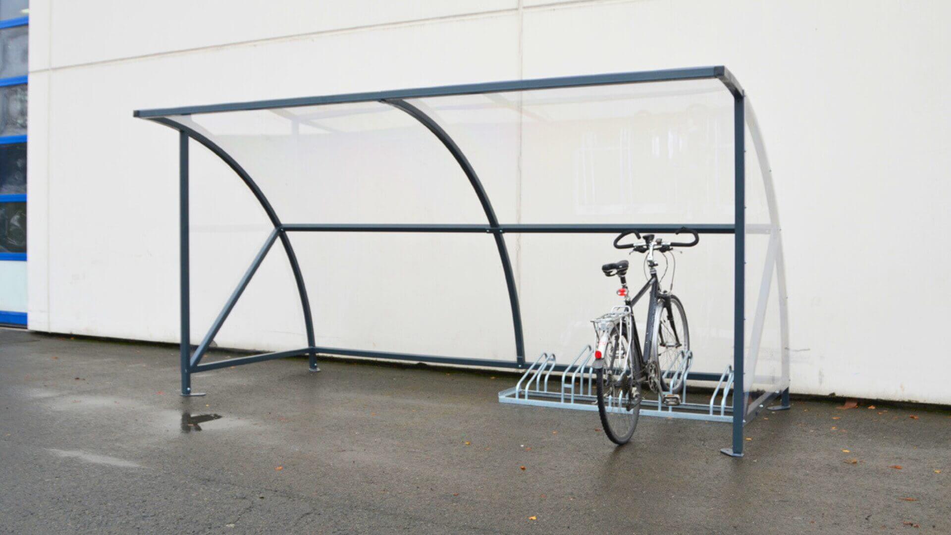 Budgetvriendelijke boogkap fietsenstalling met transparante zijpanelen en stevig stalen frame. Geschikt voor openbare ruimtes en bedrijven.