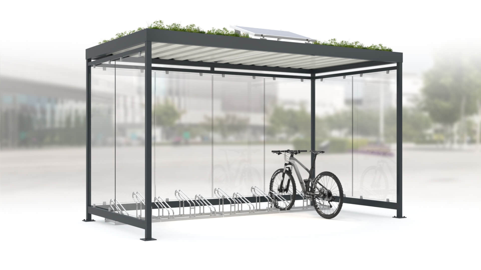 Overkapping voor fietsen, van staal en glas in kleur antraciet en voorzien van fietsenrekken.