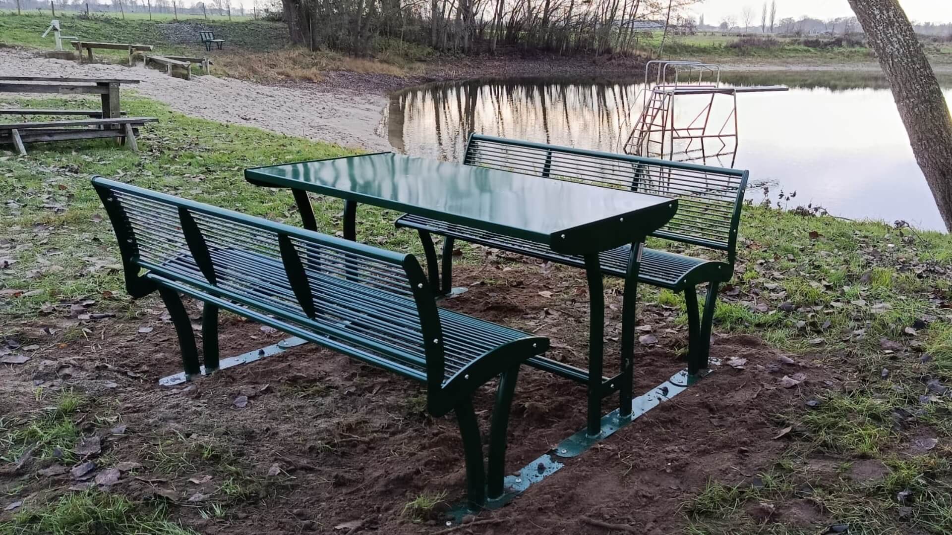 Mosgroene picknicktafel met rugleuningen voor 6 personen, in RAL 6005, geplaatst bij een recreatieplas in Wilp